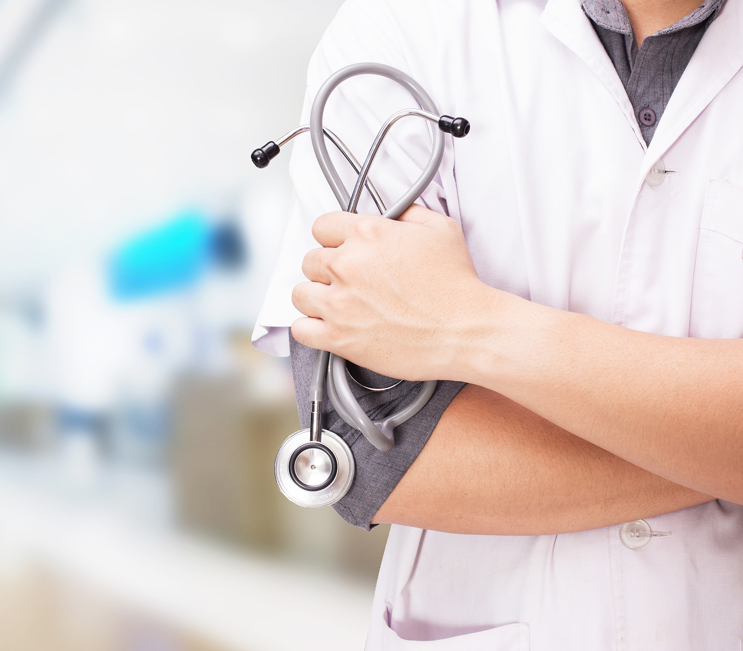 Doctor with a stethoscope in the hands and hospital background